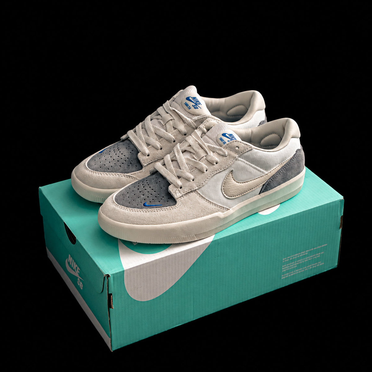 Dunk Low en crema y gris con detalles azules
